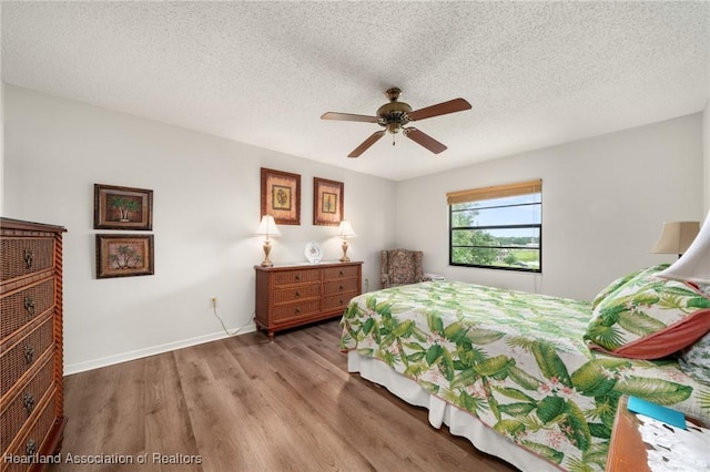 19 A Miracle Ave, Avon Park, FL 33825 - bedroom with wood finished floors, a textured ceiling, and a ceiling fan