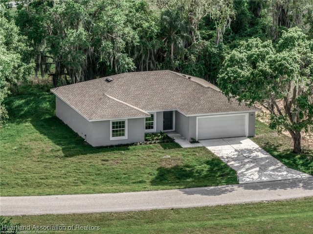 view of front of home featuring a garage and a front lawn