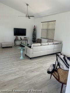living room with wood finished floors and ceiling fan