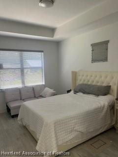 bedroom with wood finished floors