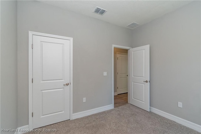 unfurnished bedroom with light carpet