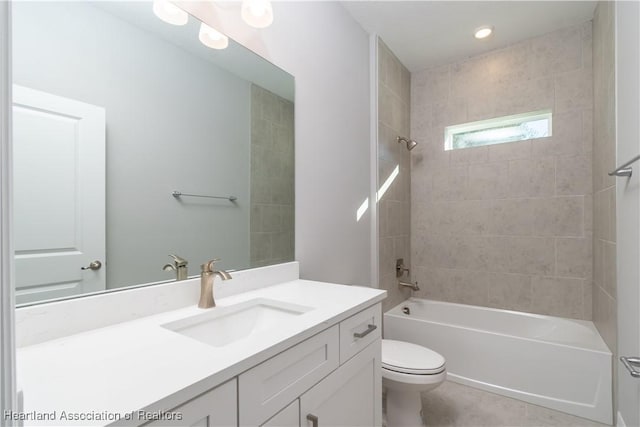 full bathroom with tiled shower / bath combo, vanity, and toilet