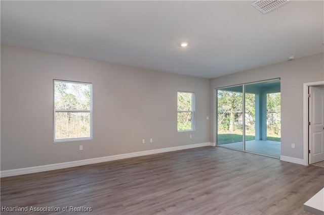 empty room with hardwood / wood-style flooring