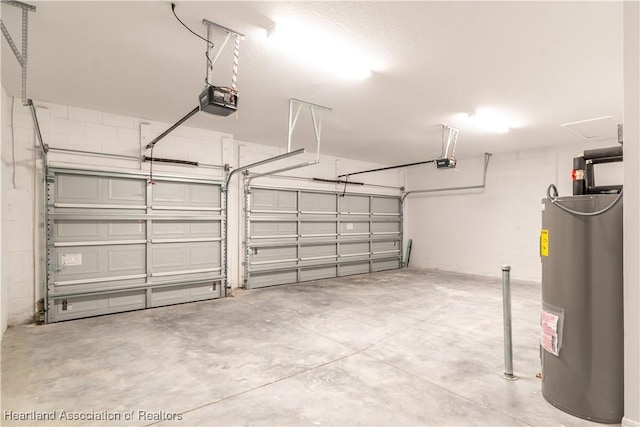 garage featuring water heater and a garage door opener