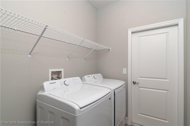 clothes washing area featuring washer and dryer