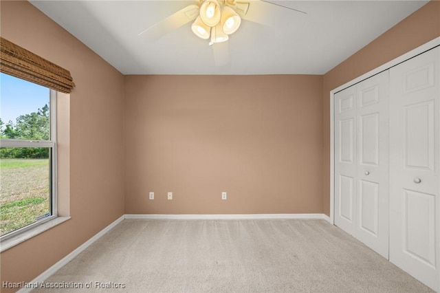 6918 San Benito Dr, Sebring, FL 33872 - unfurnished bedroom featuring light carpet, multiple windows, and baseboards