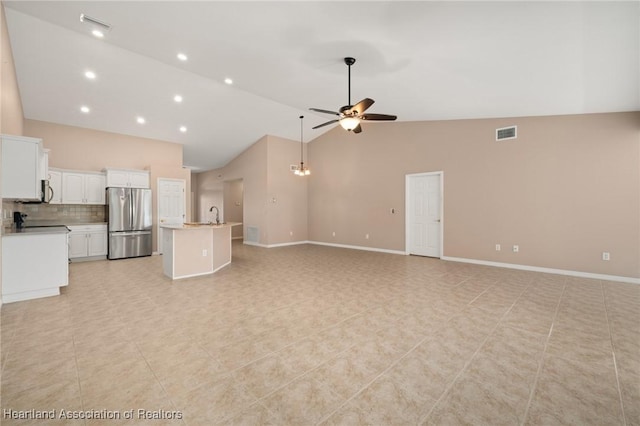 6918 San Benito Dr, Sebring, FL 33872 - unfurnished living room featuring ceiling fan, high vaulted ceiling, baseboards, a sink, and recessed lighting