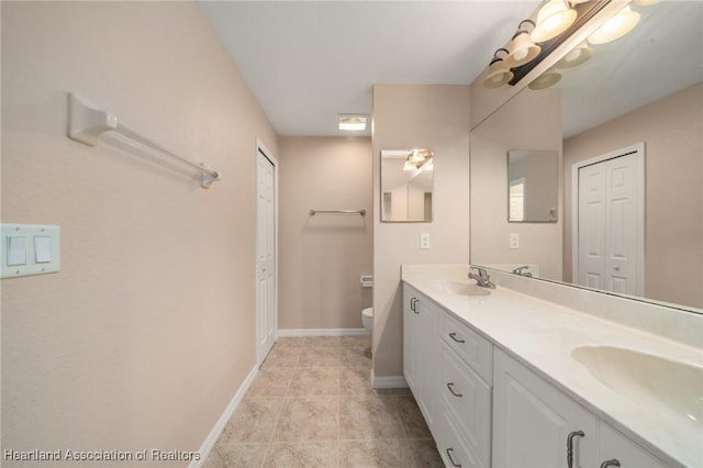 6918 San Benito Dr, Sebring, FL 33872 - bathroom with a closet, toilet, double vanity, and baseboards