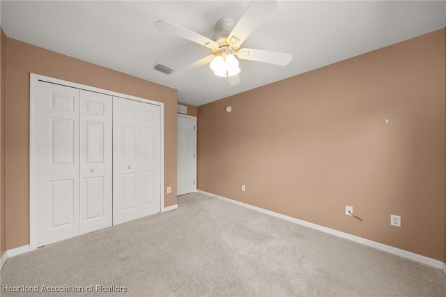 6918 San Benito Dr, Sebring, FL 33872 - unfurnished bedroom featuring a closet, light colored carpet, baseboards, and ceiling fan