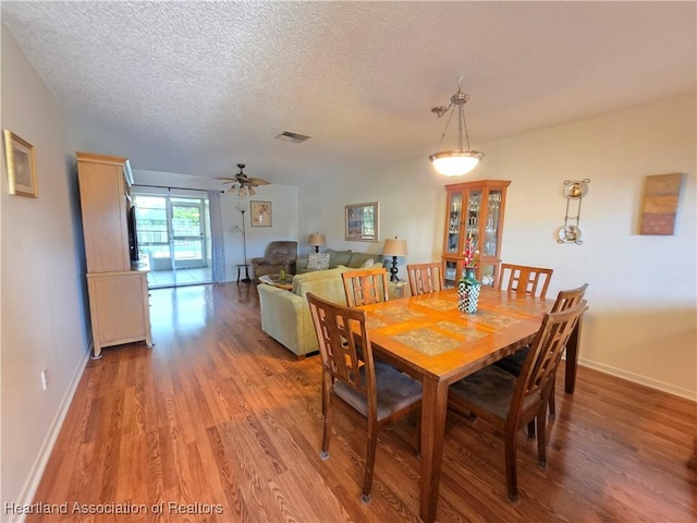 4730 Granada Blvd, Sebring, FL 33872 - dining room with light wood-style floors, a textured ceiling, and a ceiling fan