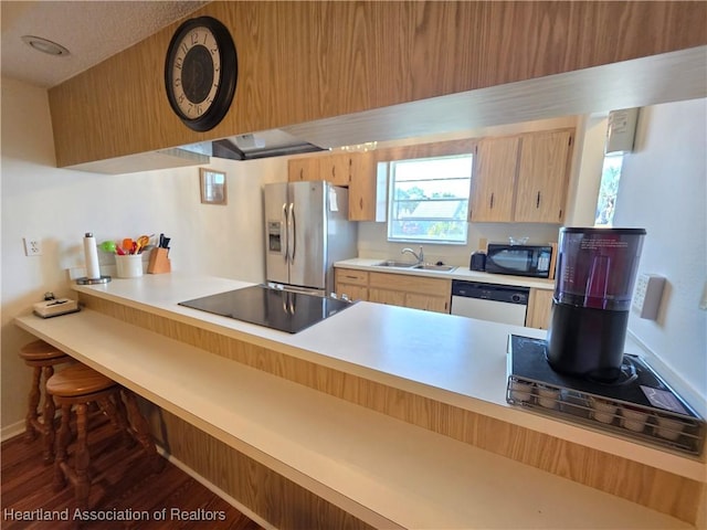 4730 Granada Blvd, Sebring, FL 33872 - kitchen with black appliances, light countertops, dark wood-style floors, and a peninsula
