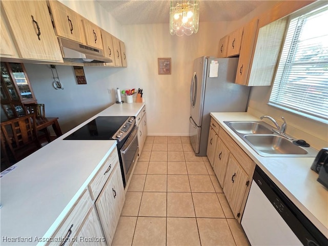 4730 Granada Blvd, Sebring, FL 33872 - kitchen with under cabinet range hood, appliances with stainless steel finishes, light countertops, a chandelier, and light tile patterned floors