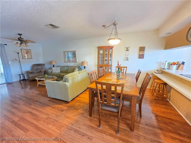 4730 Granada Blvd, Sebring, FL 33872 - dining room with light wood finished floors, ceiling fan, and a textured ceiling