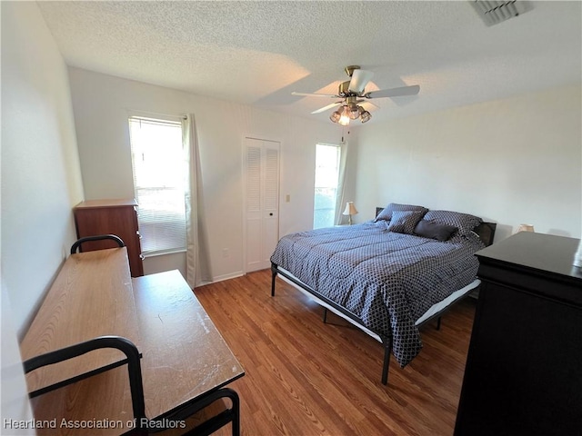 4730 Granada Blvd, Sebring, FL 33872 - bedroom with wood finished floors, a textured ceiling, ceiling fan, and a closet