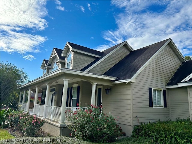 view of side of home with a porch