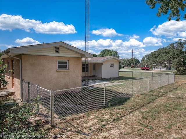 rear view of property featuring a lawn