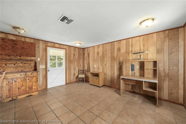 miscellaneous room with tile patterned flooring and wood walls