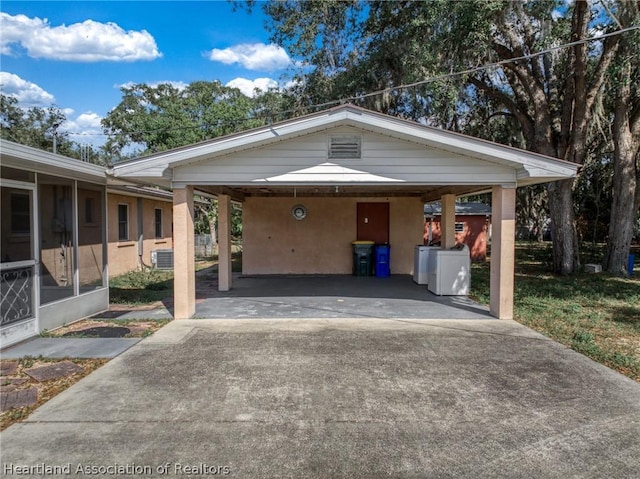 exterior space with washer and clothes dryer and a carport