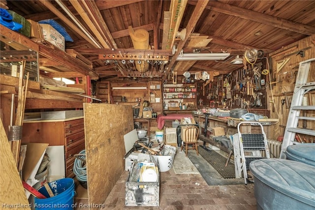 misc room featuring a workshop area and lofted ceiling with beams