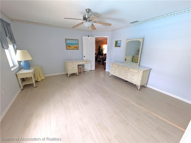 bedroom featuring ceiling fan, a spacious closet, and light hardwood / wood-style floors