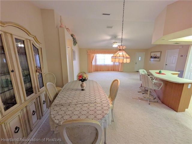 4225 Mandarin Rd, Sebring, FL 33875 - dining area featuring a ceiling fan, light carpet, lofted ceiling, and visible vents