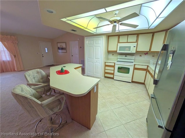 4225 Mandarin Rd, Sebring, FL 33875 - kitchen featuring light tile patterned flooring, white appliances, light countertops, and a ceiling fan