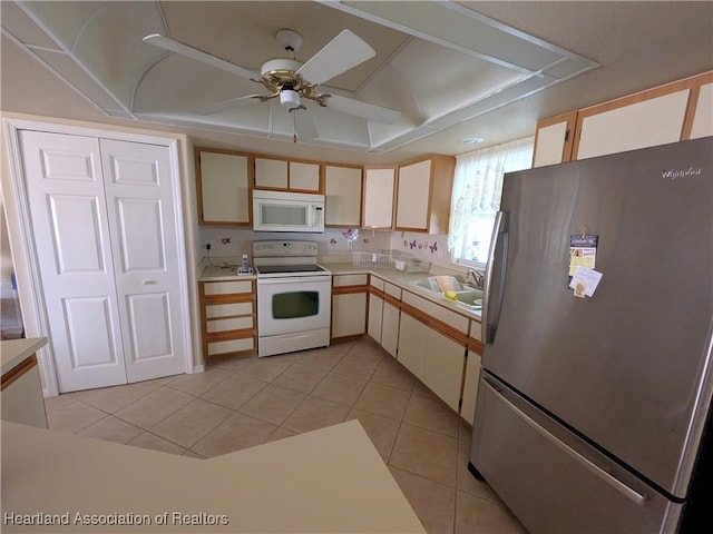 kitchen featuring light tile patterned flooring, sink, ceiling fan, and white appliances