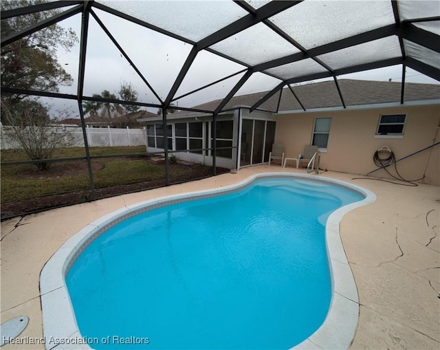 view of swimming pool with a lanai and a patio area