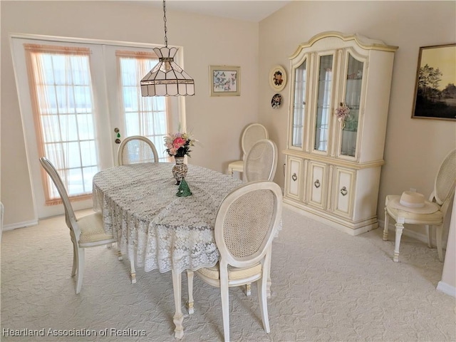 4225 Mandarin Rd, Sebring, FL 33875 - dining area with baseboards and light carpet