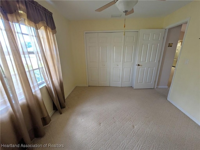 4225 Mandarin Rd, Sebring, FL 33875 - unfurnished bedroom featuring baseboards, a closet, light colored carpet, and ceiling fan
