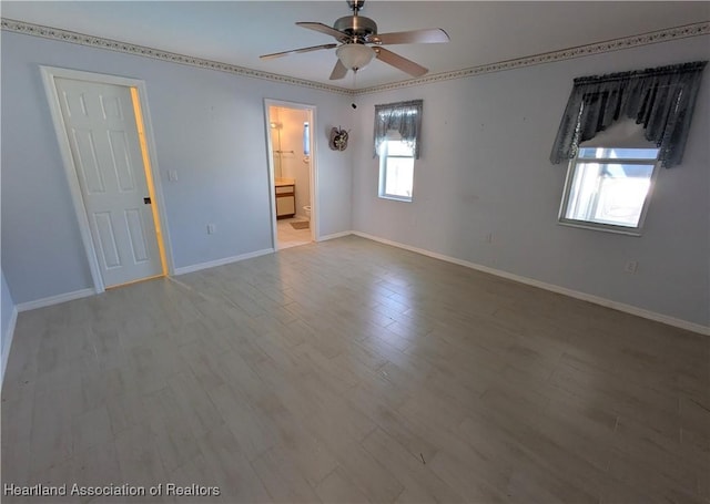 unfurnished room featuring wood finished floors, baseboards, and ceiling fan