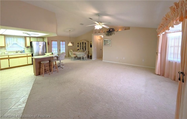 4225 Mandarin Rd, Sebring, FL 33875 - interior space with a sink, freestanding refrigerator, a breakfast bar, lofted ceiling, and light colored carpet
