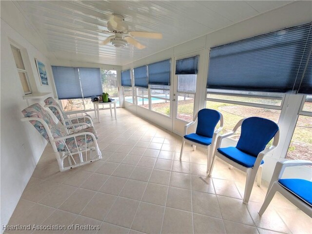 view of pool with fence, a fenced in pool, a sunroom, a lanai, and a patio area