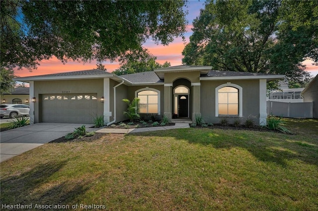 view of front of property featuring a lawn and a garage