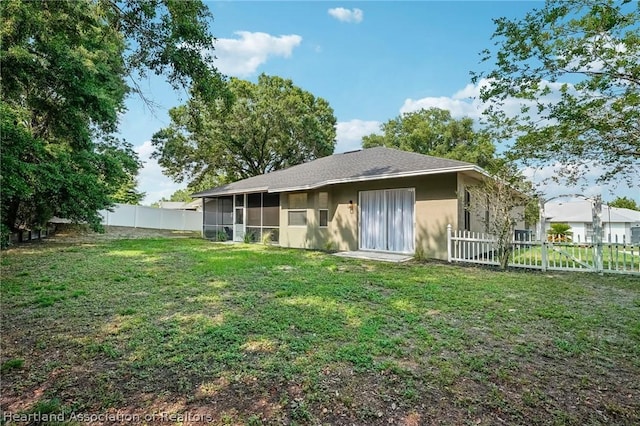 rear view of house with a yard