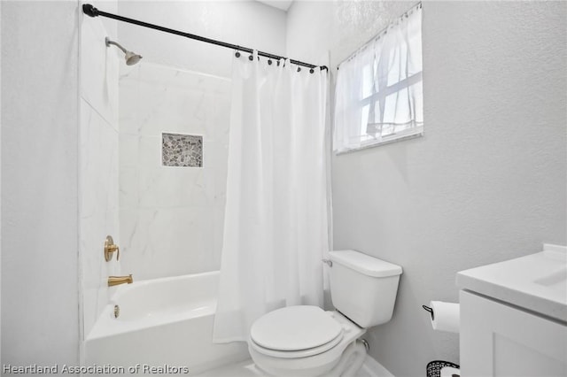 full bathroom featuring shower / bath combination with curtain, vanity, and toilet