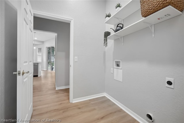 washroom featuring electric dryer hookup, hookup for a washing machine, and light hardwood / wood-style flooring