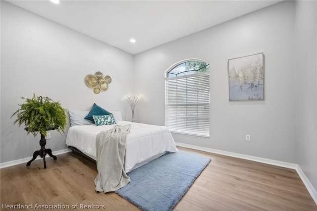 bedroom with wood-type flooring