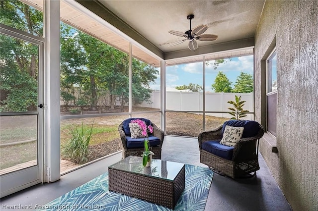 sunroom featuring ceiling fan