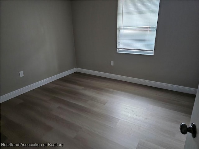 unfurnished room with hardwood / wood-style floors