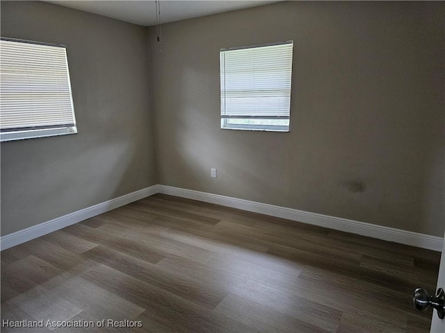 unfurnished room featuring hardwood / wood-style flooring