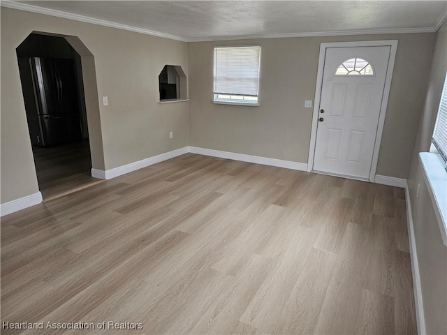 entryway featuring light hardwood / wood-style floors and crown molding