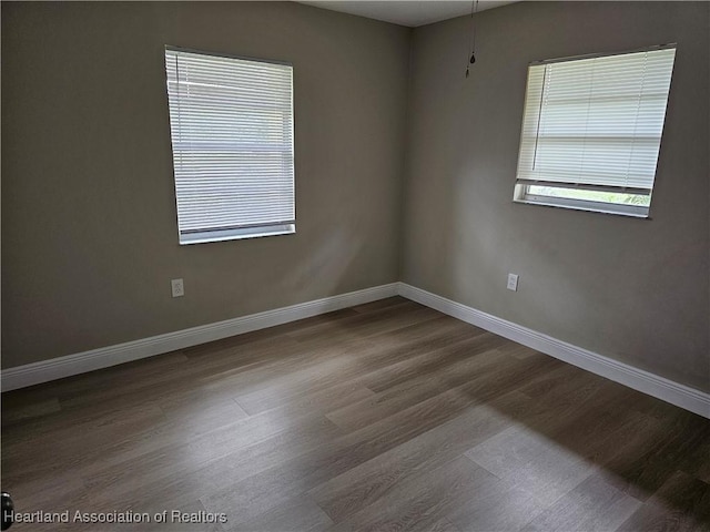 empty room with hardwood / wood-style floors