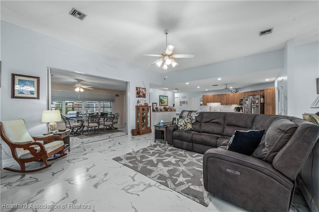 living room with marble finish floor, visible vents, and ceiling fan