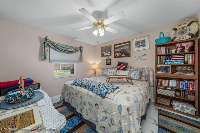 bedroom featuring baseboards and a ceiling fan