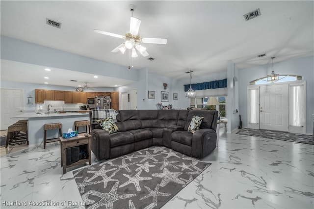 living area featuring marble finish floor, visible vents, and a ceiling fan