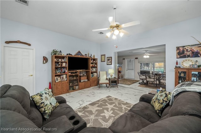 living room with ceiling fan, marble finish floor, and visible vents