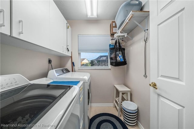 laundry room with independent washer and dryer, cabinet space, and baseboards