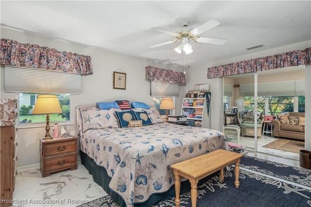 bedroom with marble finish floor, multiple windows, visible vents, and a ceiling fan