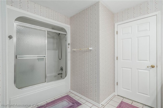 bathroom featuring tile patterned flooring, combined bath / shower with glass door, and wallpapered walls